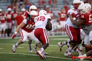 Imani Cross takes the carry during Saturday night's scrimmage. (Photo Courtesy Kelly Mosier/NU Media Relations)